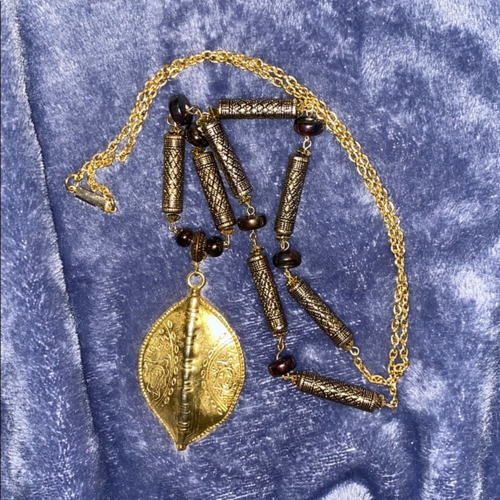 Long gold medallion style necklace. Iridescent.